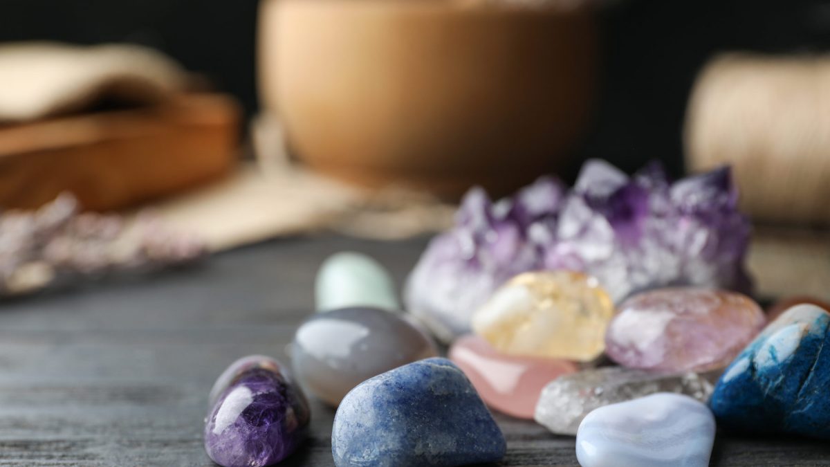 Colourful healing gemstones on a wooden table